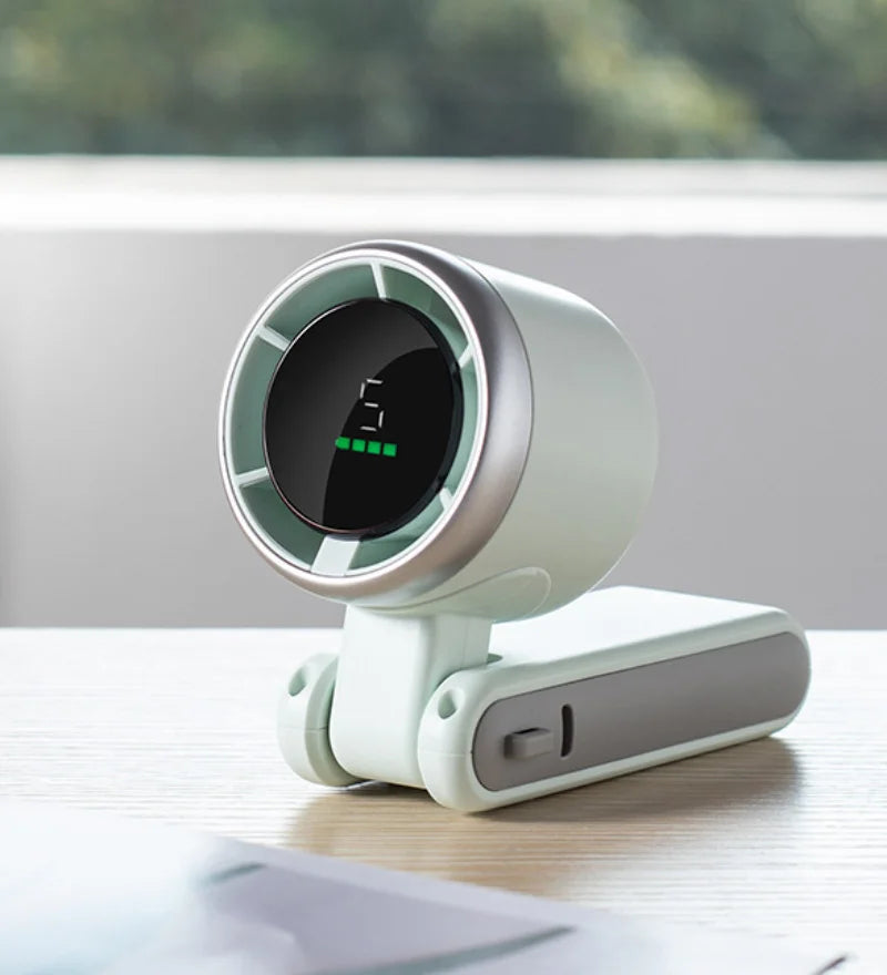 MenoMode compact fan for hot flashes with digital display and foldable design on wooden table
