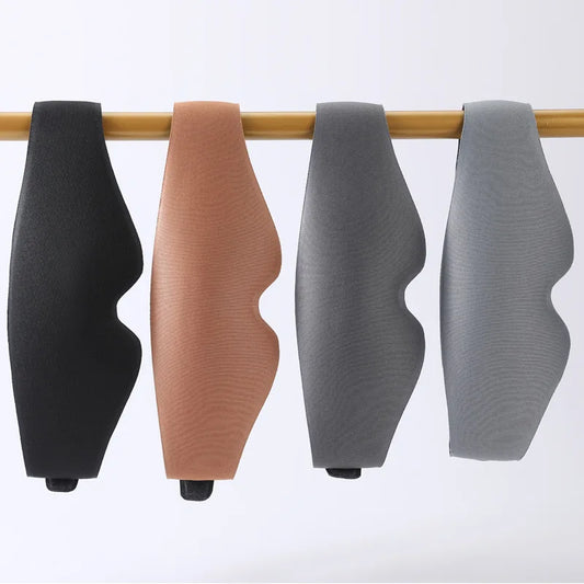 MenoMode comfort sleep mask for women in black, brown, and shades of gray hanging on wooden rod