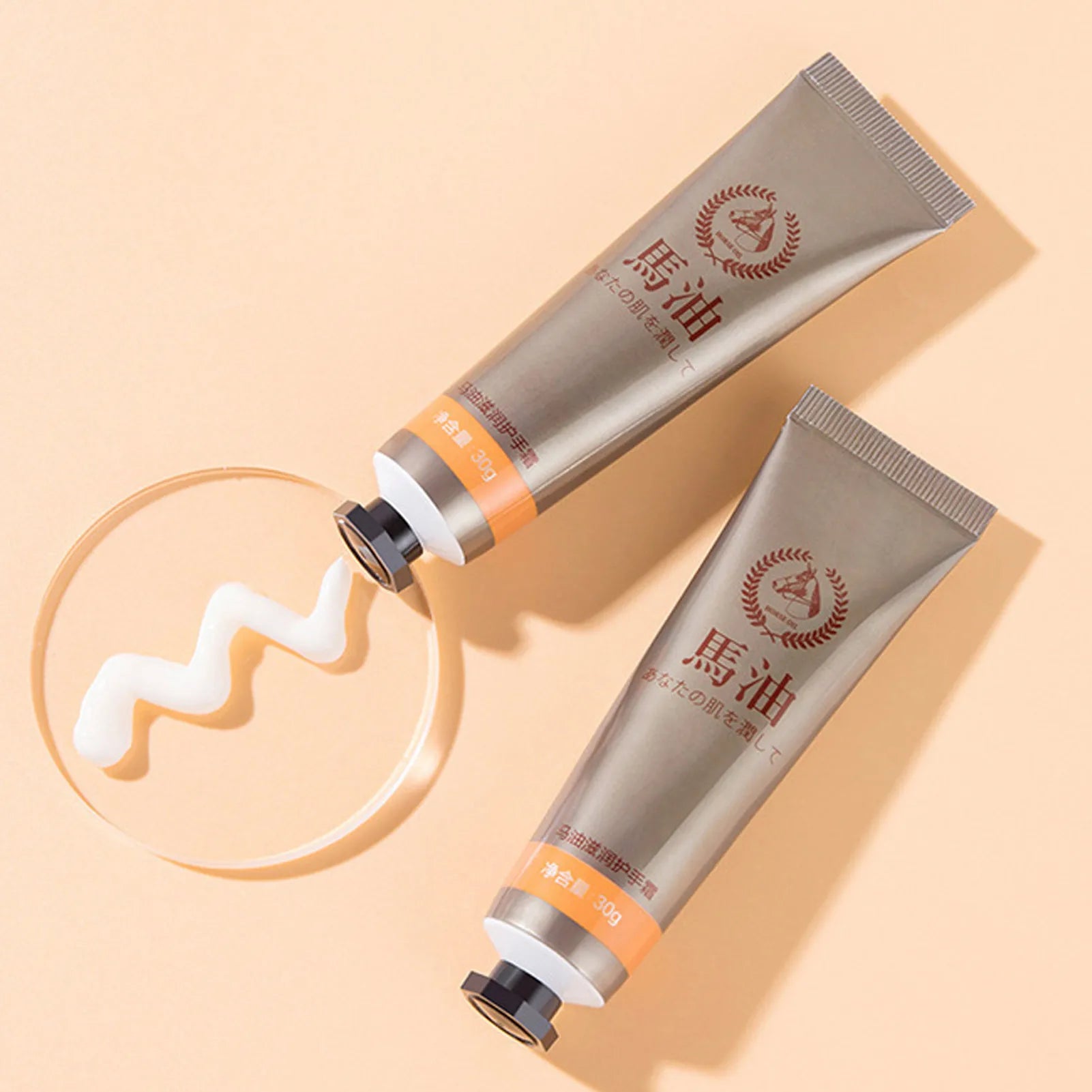 MenoMode repair hand cream for menopause in silver tubes with cream texture on beige background