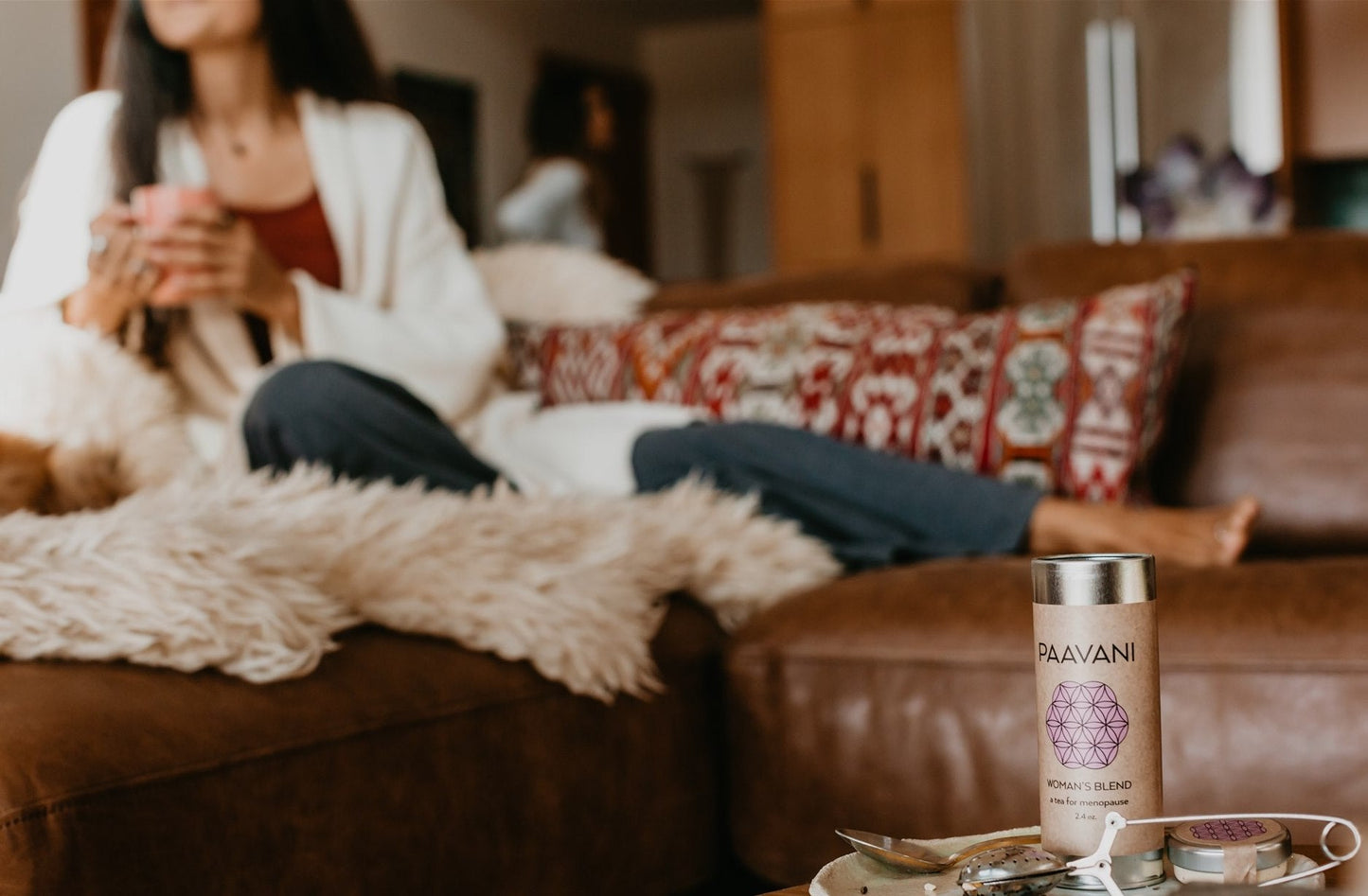 DC-PAAVANI Ayurveda ayurvedic tea for hormonal balance container on table with woman relaxing on couch